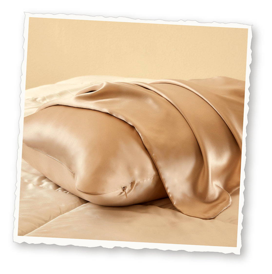 Champagne silk pillowcases stacked on a bed